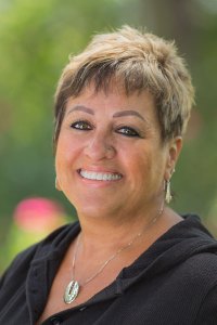 Deanna - Public Relations, smiling at the camera