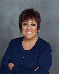 Deanna - Public Relations, smiling at the camera